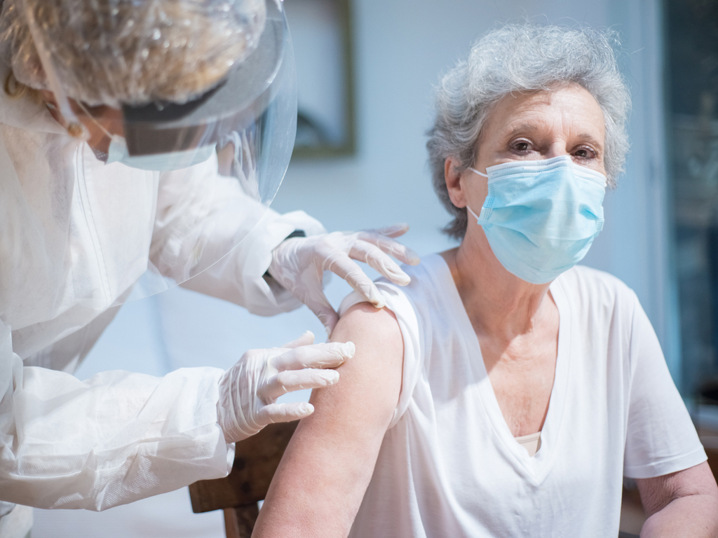 Elderly person receiving a vaccination